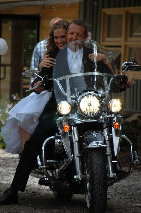 God Talks coach Andrew Dickson riding a Harley with his American bride after their 2010 wedding